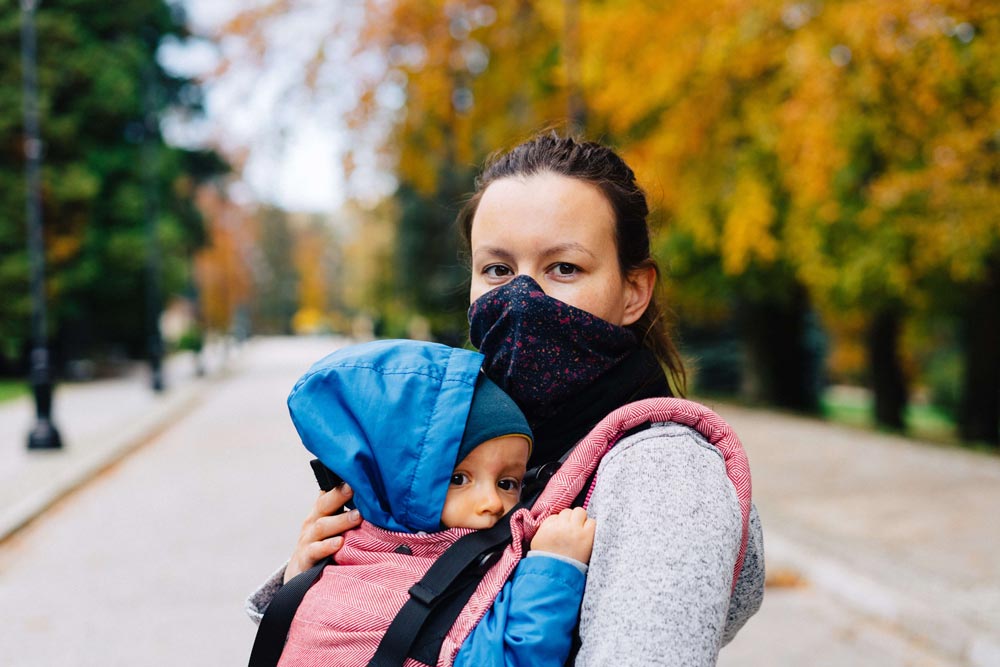 Woman and child wearing masks outside