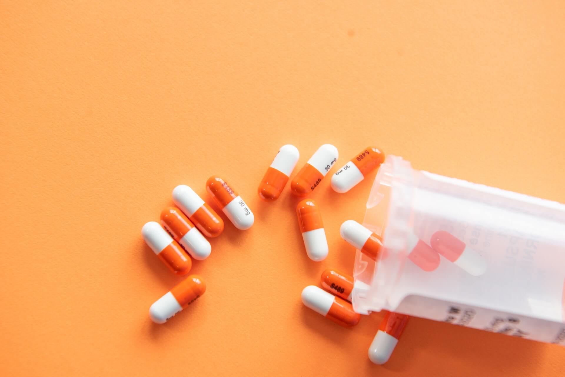 Photo of pills spilling out of a prescription bottle