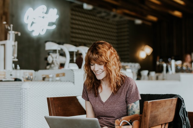 Woman smiling at her laptop